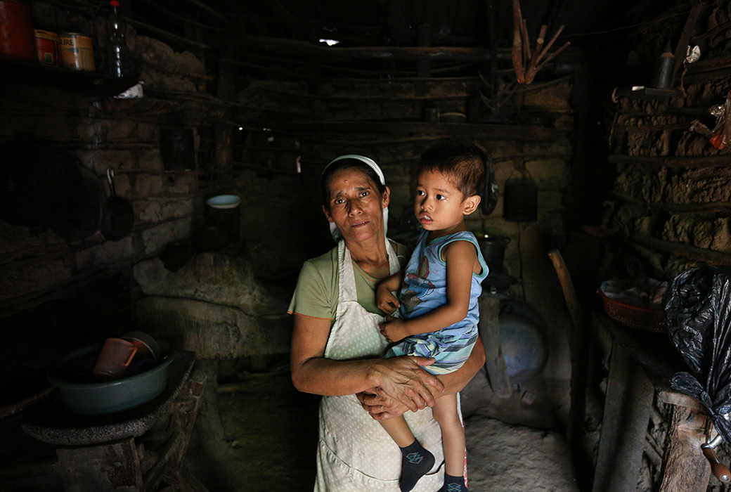 "When I cook, I usually send the kids outside because the smoke is bad for their health," said grandmother Vertila in their makeshift indoor kitchen in El Salvador.