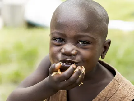 2020, Cite Soleil Haitian boy enjoying a warm meal