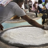Cooking Cassava Bread on Large Iron Griddles