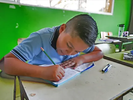 School Boy seated at desk El Salvador