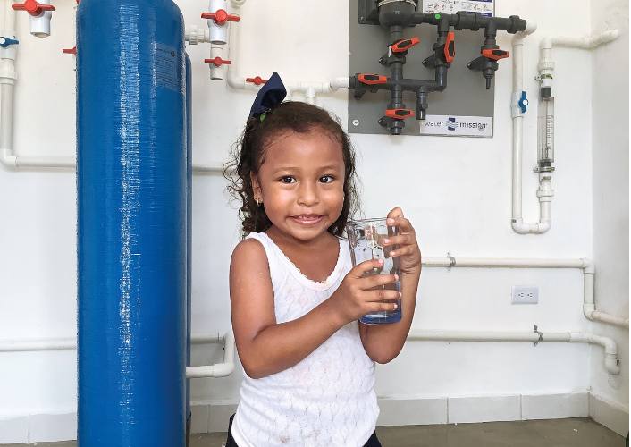 Young Mexican girl holds a glass of safe water- FFTP 2023 annual report highlights aid given