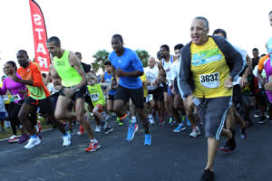 Racers take off with Yohan Blake, center, at the starting line in last year's 5K Walk/Run.