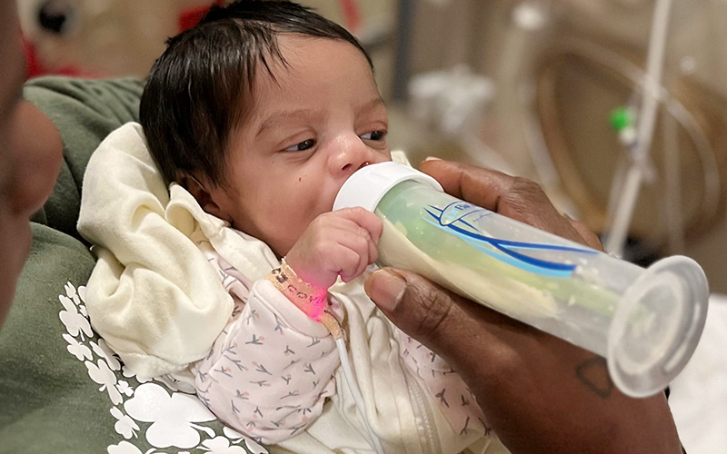 A baby is being fed with a bottle.