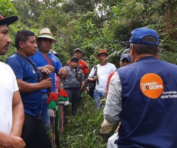 A representative from CODESPA, and FFTP partner, talks with farmers in Colombia where we fight poverty