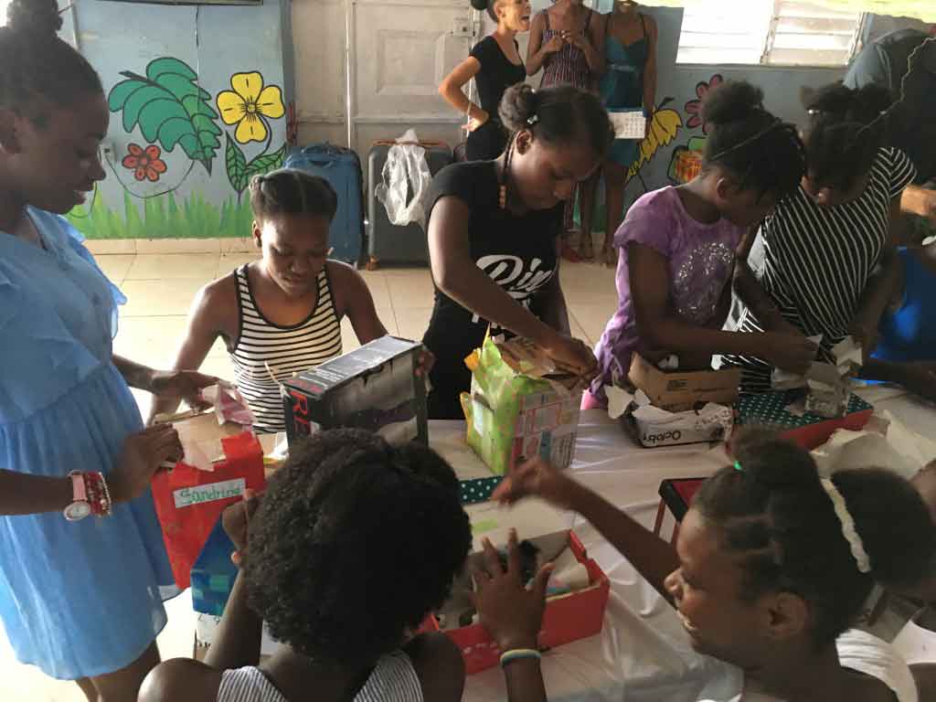 Children in Haiti eagerly opening their gifts.