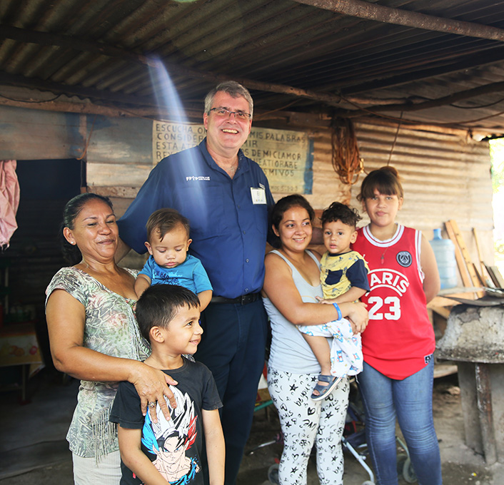 Ed Raine visits with Elsy Nohemi and her children, and her mother Karla during a mission trip to Honduras.