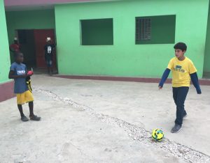 Georgos Jusakos, 13, of Orlando, kicks around a soccer ball that was given to children at an orphanage in Ganthier, Haiti. Jusakos traveled to Haiti in August with Food For The Poor and a group of donors from Orlando and Palm Beach County. (Photo/Food For The Poor)