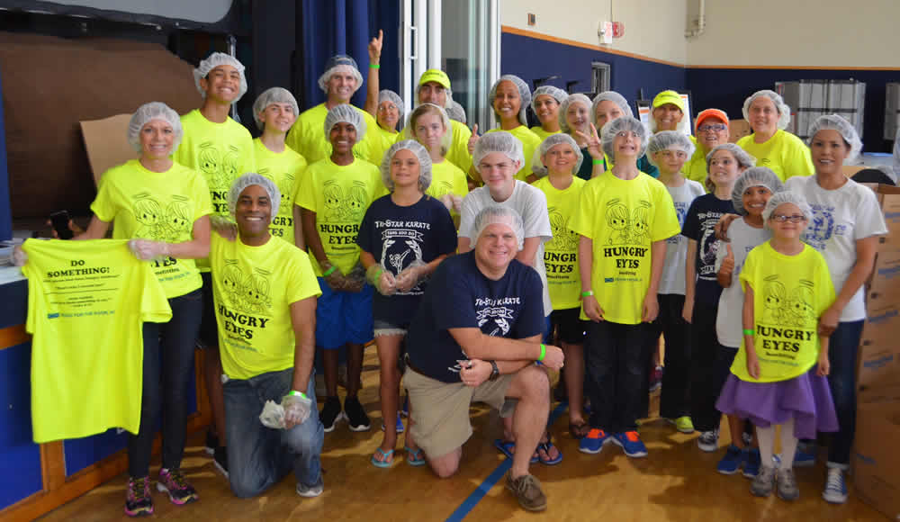 Hungry Eyes Team Packs Meals with a Heart for Haiti