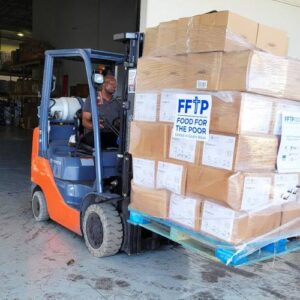 A forklift full of boxes of aid for Hurricane Helene victims is transported from the FFTP warehouse