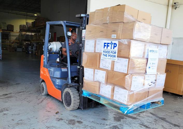 A forklift full of boxes of aid for Hurricane Helene victims is transported from the FFTP warehouse