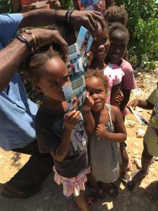 Chrissie Ferguson of Lake Worth traveled to Haiti with Food For The Poor in August, her second trip. She presented photos to the children that she had taken on her first trip to Haiti in November. (Photo/ Food For The Poor)