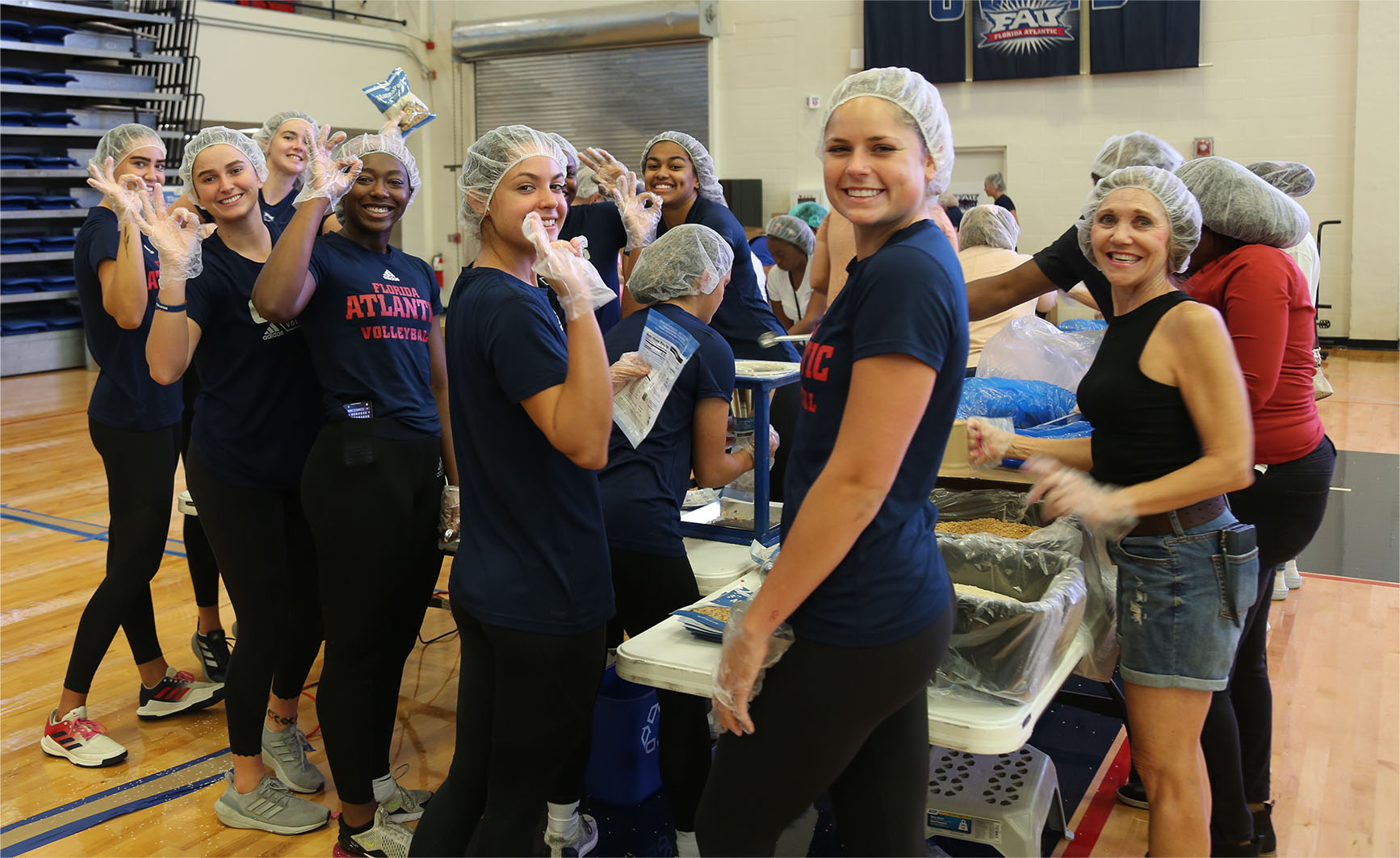 Florida Atlantic University Owls women’s volleyball team was eager to pack meals at FAU Arena