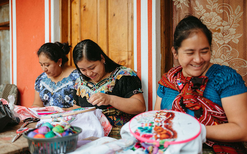 A group of women creating handmade crafts.