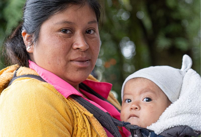 A Lenca woman with a baby carried on her chest.