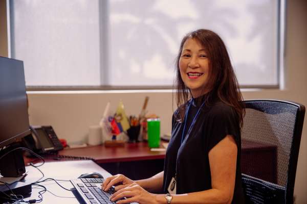 Sandra Chavez Quan working at her desk
