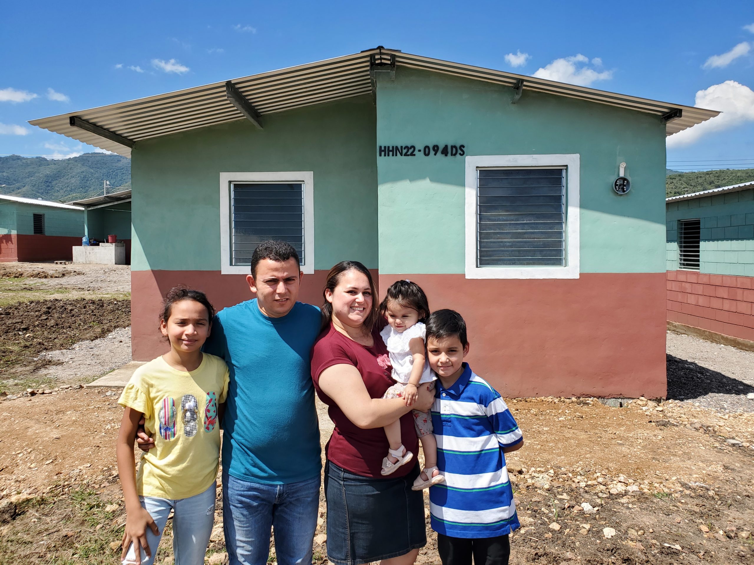A grateful family stands in front of their new home in Villanueva, Honduras, provided by longtime Food For The Poor donor Tim Thoman