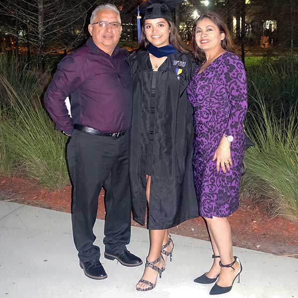 Andrea Delgado at graduation with her parents