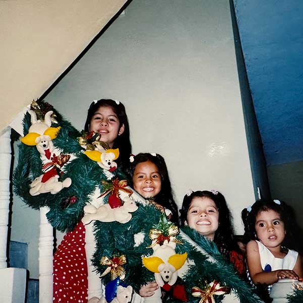 Andrea Delgado with her sisters and cousins at Christmas