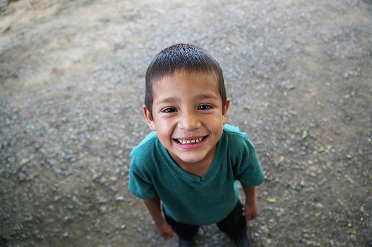 A boy in an Angels of Hope home in Honduras smiles for the camera.