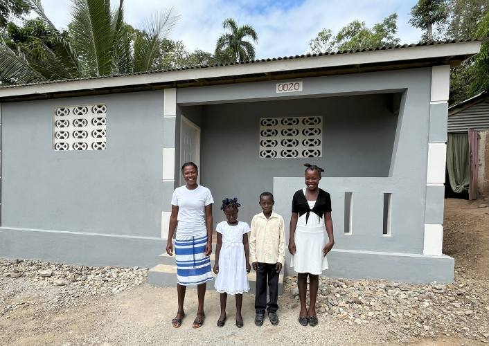 FFTP donors build hope in haiti for family who stands in front of their new home