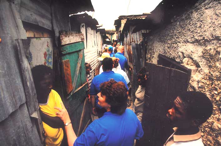 Dr. Lynne Nasrallah visits with children and parents hungry for food, water and dignity in a slum in Cité Soleil, Haiti, an area notorious for gangs and crime.