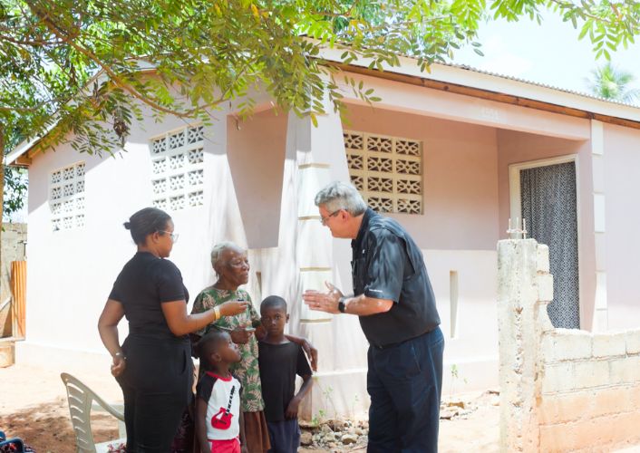 FFTP President/CEO Ed Raine with a family outside their new home thanks to FFTP Haiti project