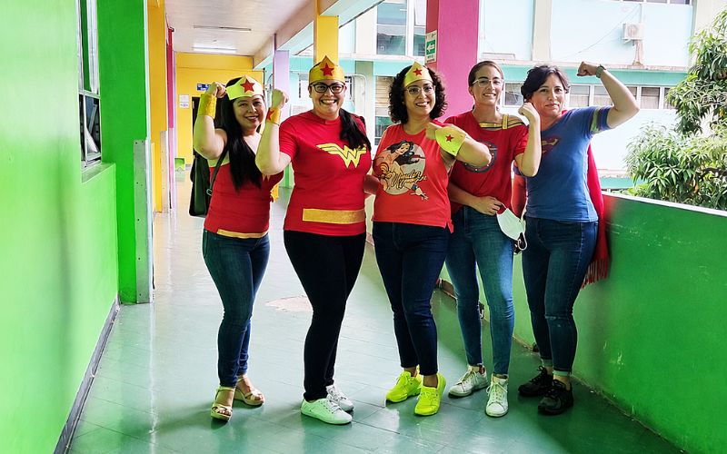 Monica stands with friends in Hospital Esceula, dressed as superheroes