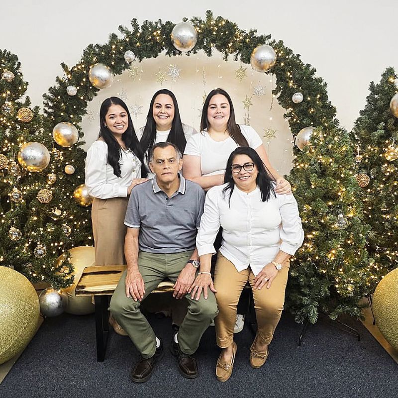 Monica and her family pose for a Christmas photo