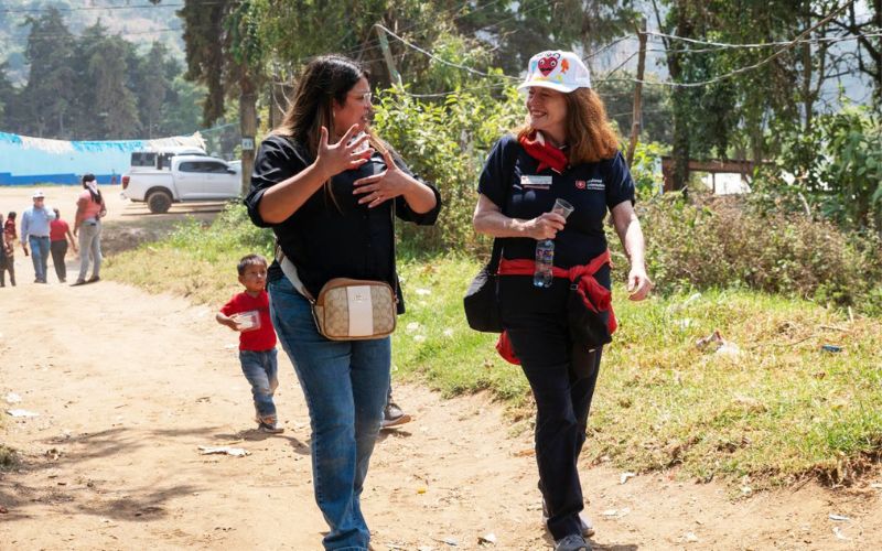Jessica walks with another agency leader in El Tablon, Guatemala