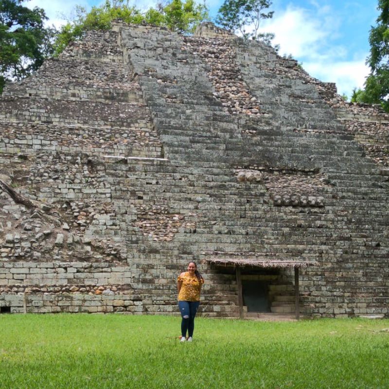 Monica stands in front of ancient ruins