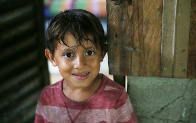 A young boy in Honduras smiles for the camera
