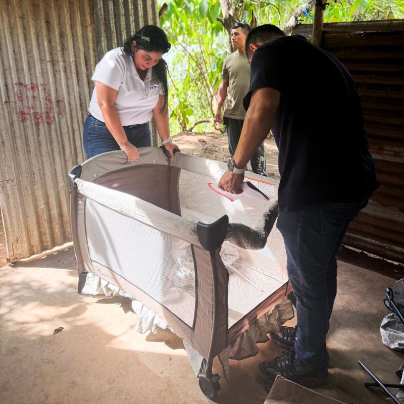 A man and woman assemble a baby crib