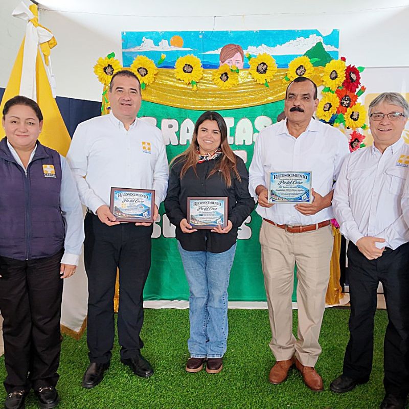 Jessica holds a certificate of recognition with others in the community