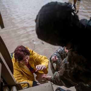 A woman is rescued from rising floodwaters by the National Guard in Puerto Rico. Photo REUTERS/Ricardo Arduengo
