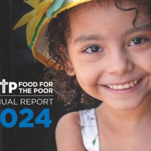 A young girl smiles on the cover of the Food For The Poor Annual Report