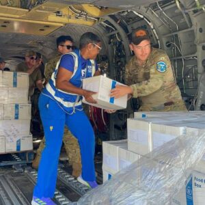 FFTP employee working with U.S. government to load supplies into a helicopter for disaster relief after Hurricane Melissa