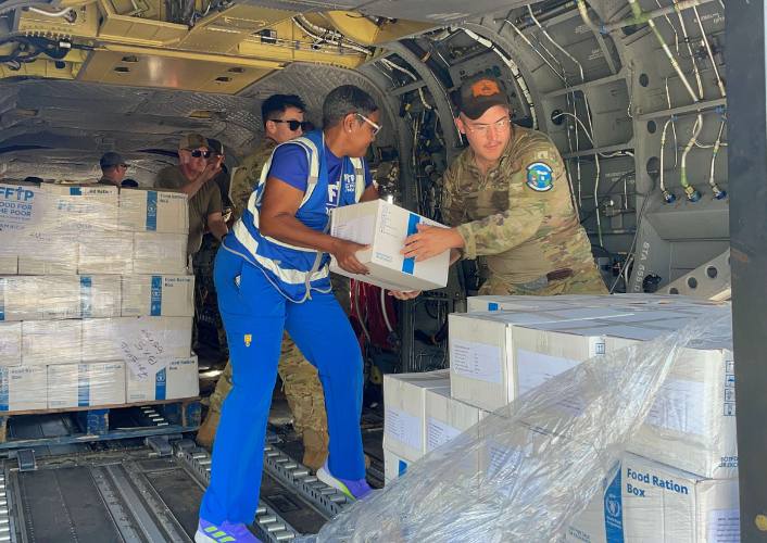FFTP employee working with U.S. government to load supplies into a helicopter for disaster relief after Hurricane Melissa
