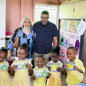 Founders of Christos Ministries stand with children in a school they built with Food For The Poor
