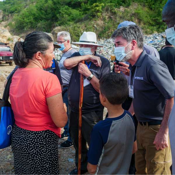 Frederico Garza talks to woman and her son at Villanueva dump in Honduras