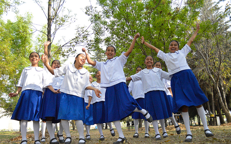 A group of girls in blue skirts.