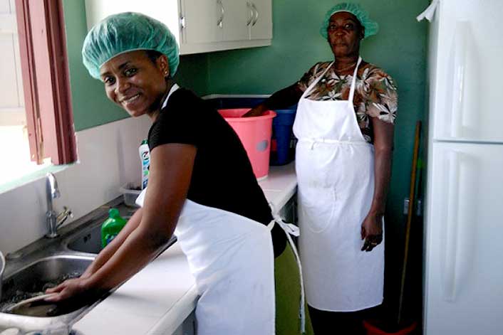 Grenada - Two females working in the kitchen