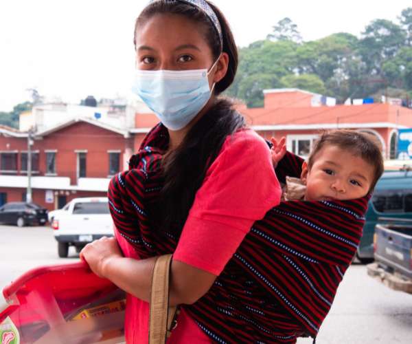 A young woman in Guatmala where FFTP fights poverty carries her baby on her back