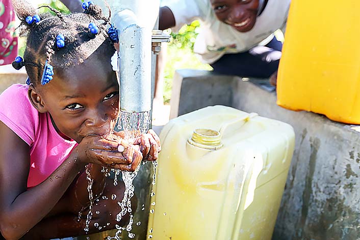 Haiti - Female child drinking tap water