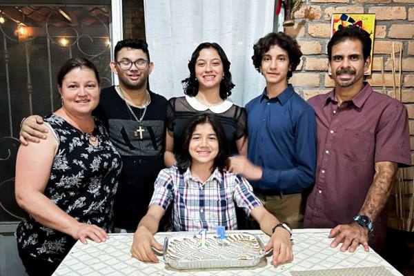 Jesus stands with his wife and children as they celebrate their son's birthday