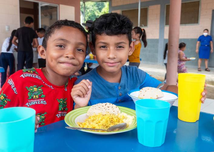 Two children in Honduras at a feeding center supported by FFTP showing importance of international school meals day