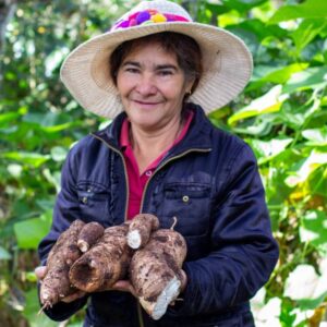 Lorenza in Honduras holds her coffee crop celebrating International Women's Day