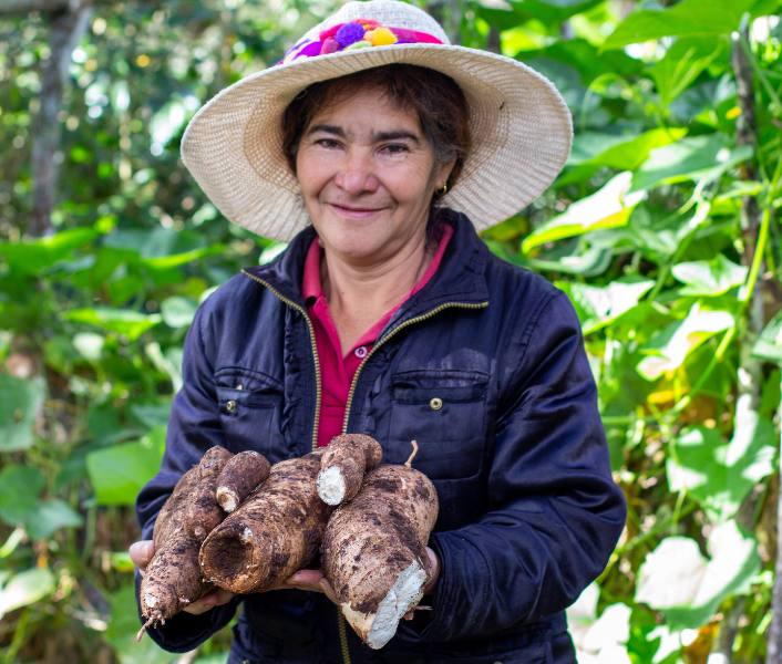 Lorenza in Honduras holds her coffee crop celebrating International Women's Day