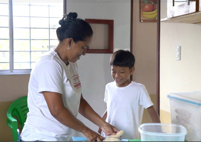Patricia and her son Anders stand in the kitchen together preparing food, international womens day fftp