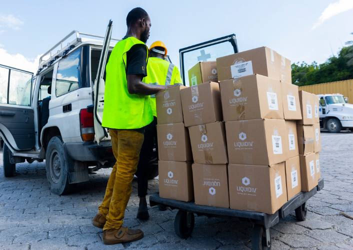 A warehouse worker unloads boxes of Liquid IV in Haiti FFTP expands partnership with Liquid I.V.