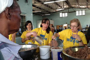 At Food For The Poor's Feeding Center in Port-au-Prince, (L to R) Edith Ayala, Virginia Canavan and Karen Dix helped to serve hot meals to the destitute.